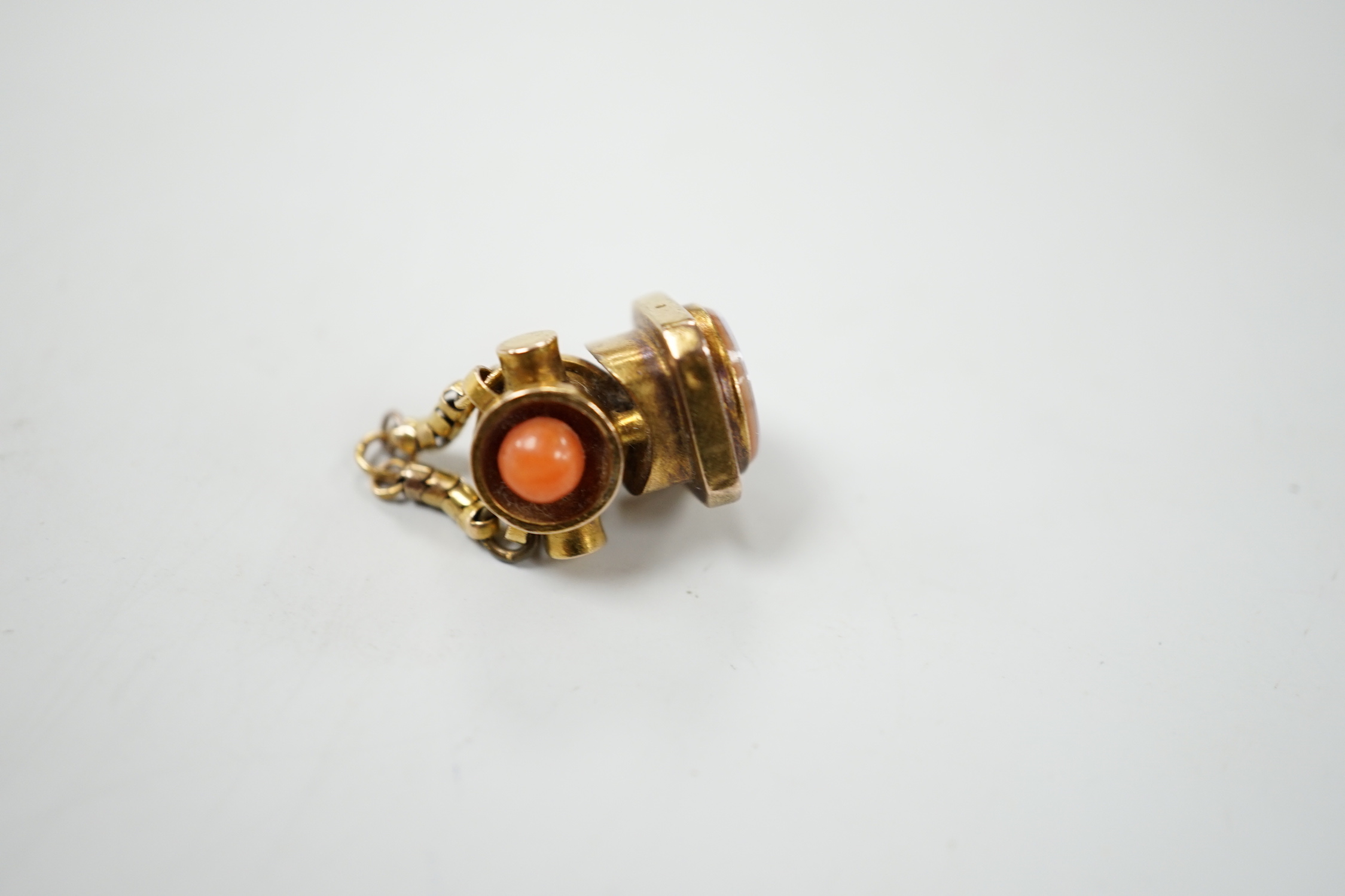A 19th century novelty gold, coral and sardonyx mounted fob seal, modelled as a search light